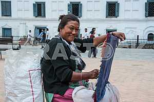 A woman in the square sells hand-made decorations