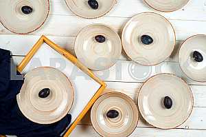 Blank white dish on a wood background.