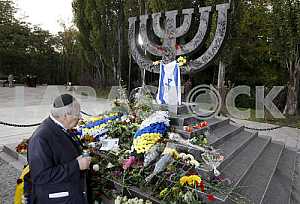 People light candles and lay flowers