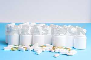 Many pills and tablets isolated on light blue background