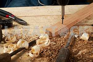 Carpenter tools on wooden table with sawdust. Circular Saw.