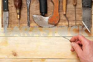 Carpenter tools on wooden table with sawdust. Circular Saw.