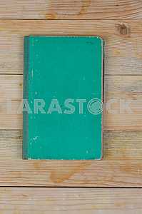 Open book, stack of hardback books on wooden table. Back to school. Copy space