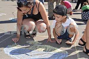 Children draw on asphalt