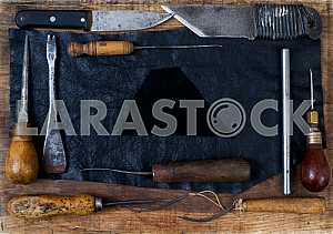 Different construction tools on a wooden background - screwdriver, caliper.