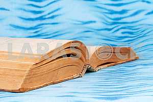 Old and used hardback books or text books on wooden table. Books and reading are essential for self improvement, gaining knowledge and success in our careers, business and personal lives. Copy space