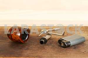 Smoking pipe on a wooden table. Aroma. Copy space
