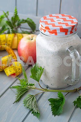 Smoothie with apples, bananas, nettle. Organic diet, healthy lifestyle concept. Tape mesure