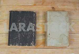 Open book, stack of hardback books on wooden table. Back to school. Copy space