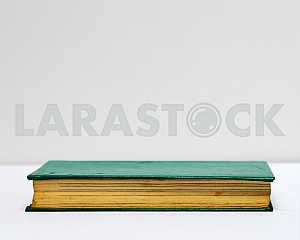 Stack of hardback books on blue cloth. Back to school. Copy space