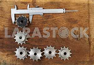 Different construction tools on a wooden background - screwdriver, caliper.