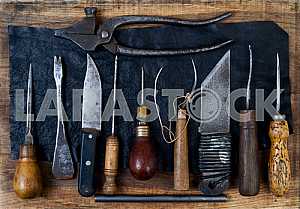 Different construction tools on a wooden background - screwdriver, caliper.
