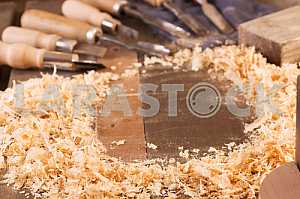 Carpenter tools on wooden table with sawdust. Circular Saw. Carpenter workplace top view