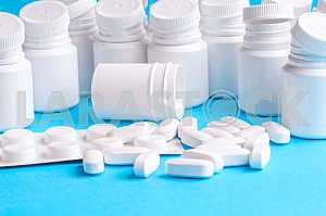 Many pills and tablets isolated on light blue background