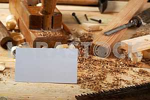 Carpenter tools on wooden table with sawdust. Circular Saw.