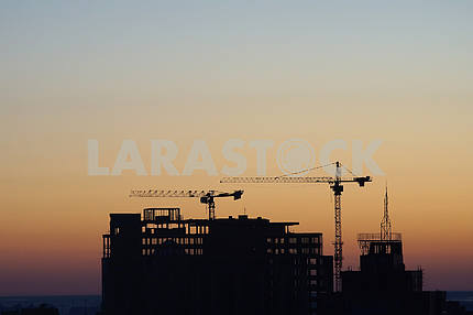 House under construction on a sunset background