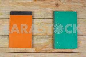Open book, stack of hardback books on wooden table. Back to school. Copy space