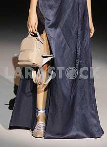 Model holds the purse in his hand during a demonstration outfit by Ukrainian designer Katerina Kvit