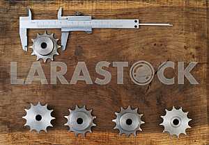 Different construction tools on a wooden background - screwdriver, caliper.