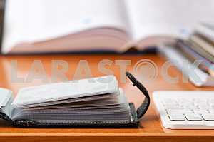 Stack of hardback books on wooden table. Back to school. Copy space. Top view