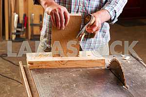 Carpenter tools on wooden table with sawdust. Circular Saw. Carpenter workplace top view