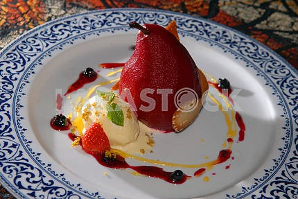 Marinaded pear with ice-cream and berries