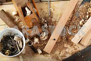 Carpenter tools on wooden table with sawdust. Circular Saw.