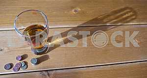 A glass of juice on a wooden table.