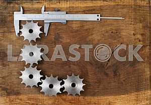 Different construction tools on a wooden background - screwdriver, caliper.