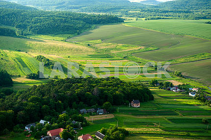 Aerial view on green and yellow parts of fields and countryside