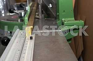 Different construction tools on a wooden background - screwdriver, caliper.