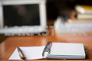 Stack of hardback books on wooden table. Back to school. Copy space. Top view