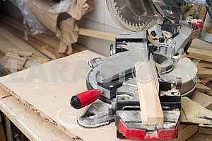 Different construction tools on a wooden background - screwdriver, caliper.