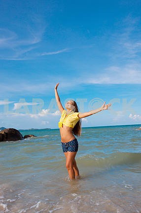Happy young woman against azure sea