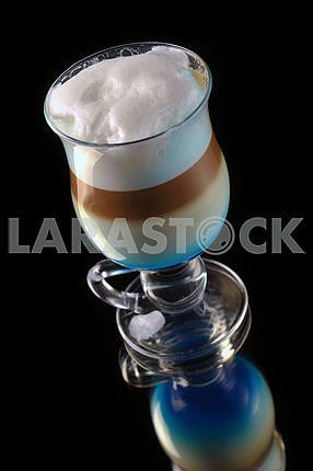 cocktail with coffee and whipped milk and liqueur curacao