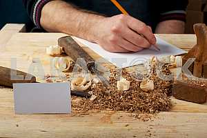 Carpenter tools on wooden table with sawdust. Circular Saw.