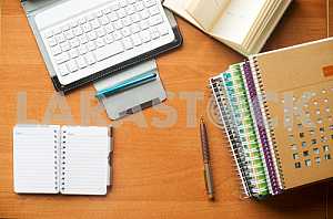 Stack of hardback books on wooden table. Back to school. Copy space. Top view