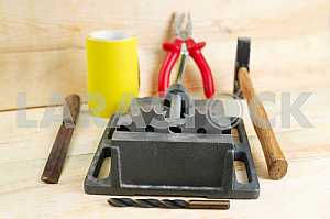 Different construction tools on a wooden background - screwdriver, caliper.
