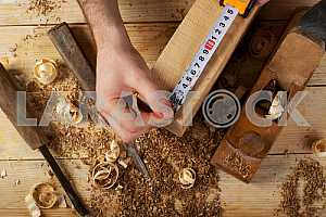 Carpenter tools on wooden table with sawdust. Circular Saw.