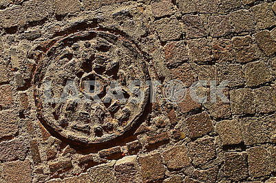 Stone textured pavement and old dirty manhole with metal cover