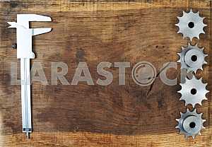 Different construction tools on a wooden background - screwdriver, caliper.