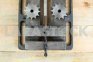 Different construction tools on a wooden background - screwdriver, caliper.