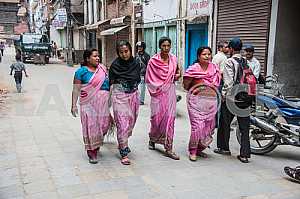 Women in pink saris are on Takmandu street.