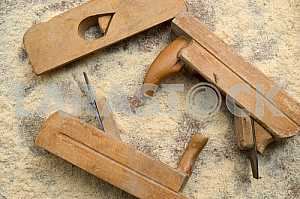 Different construction tools on a wooden background - screwdriver, caliper.