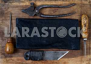Different construction tools on a wooden background - screwdriver, caliper.