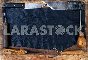 Different construction tools on a wooden background - screwdriver, caliper.
