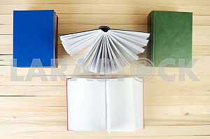 Stack of hardback books on wooden table. Back to school. Copy space