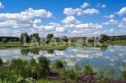 Lake and blue sky with white clouds