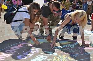 Children draw on asphalt