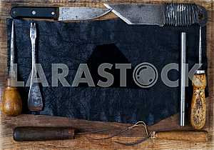 Different construction tools on a wooden background - screwdriver, caliper.